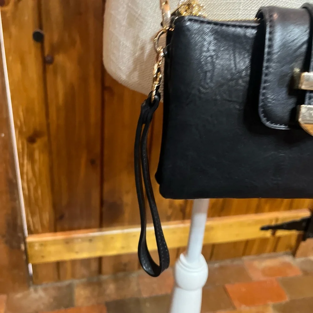 Madison West black wristlet 5 inches high by 7 inches wide with shoulder strap
